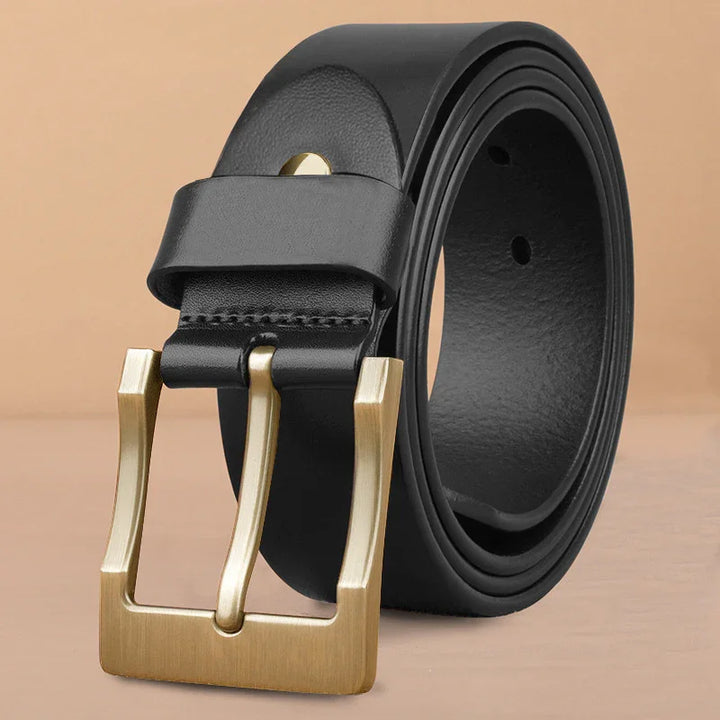Black leather belt with brushed gold rectangular buckle on beige background
