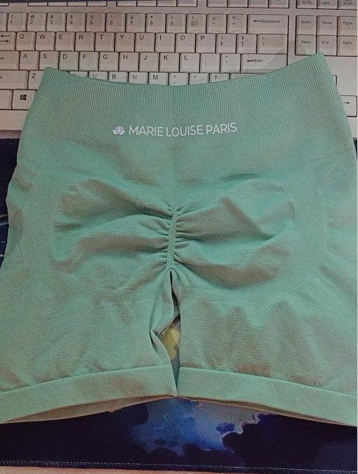 Light green MARIE LOUISE PARIS seamless shorts on keyboard background, scrunch detail