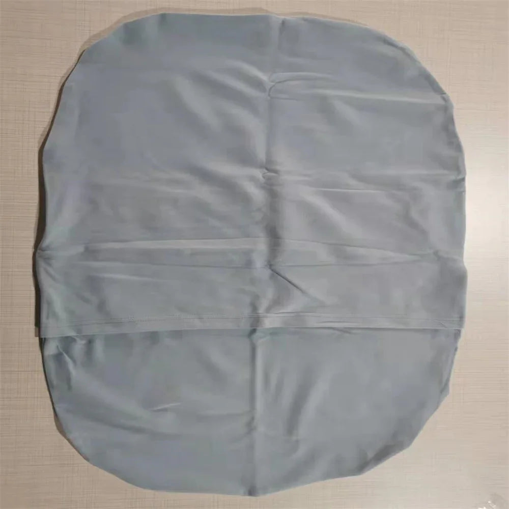 Gray microfiber cleaning cloth laid flat on beige surface with visible creases