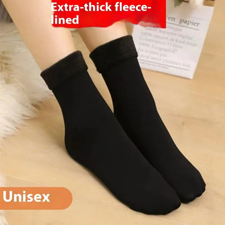 Unisex black extra-thick fleece-lined socks on wooden floor with red and white text