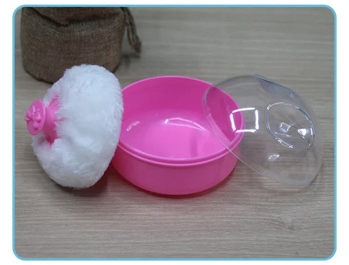 Pink plastic container with clear lid and white fluffy powder puff on wooden surface