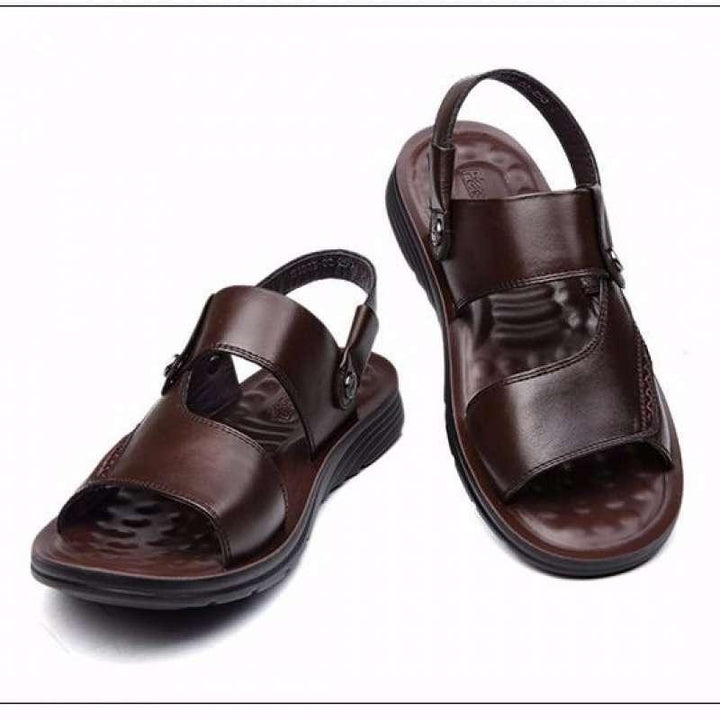 Pair of brown leather men's sandals with adjustable straps and cushioned soles on white background