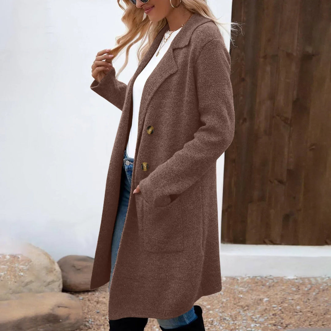 Woman wearing a brown buttoned wool coat over white top and jeans outdoors