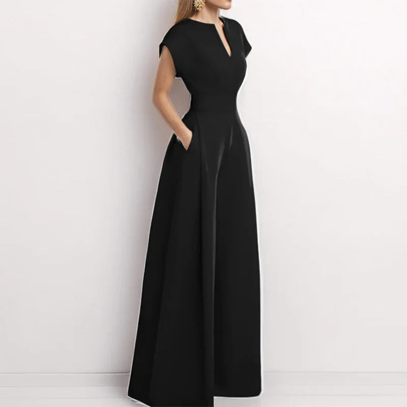 Woman wearing elegant black floor-length dress with short sleeves and V-neck collar