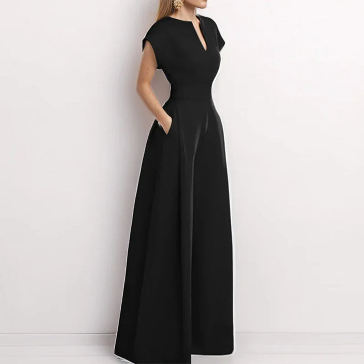 Woman wearing elegant black floor-length dress with short sleeves and V-neck collar
