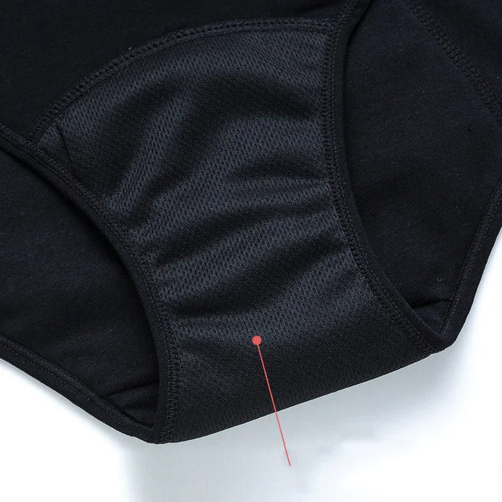 Close-up of black breathable mesh fabric on protective underwear detail with red pointer