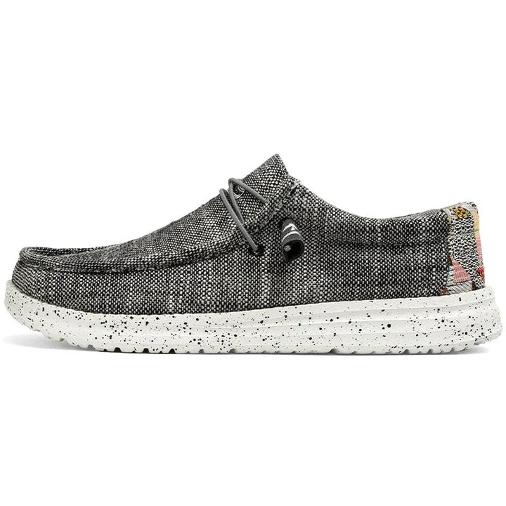 Black and white speckled casual slip-on shoe with fabric upper and speckled rubber sole