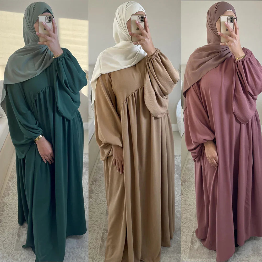 Three modest maxi dresses in green, beige, and mauve with matching hijabs, worn by women taking mirror selfies