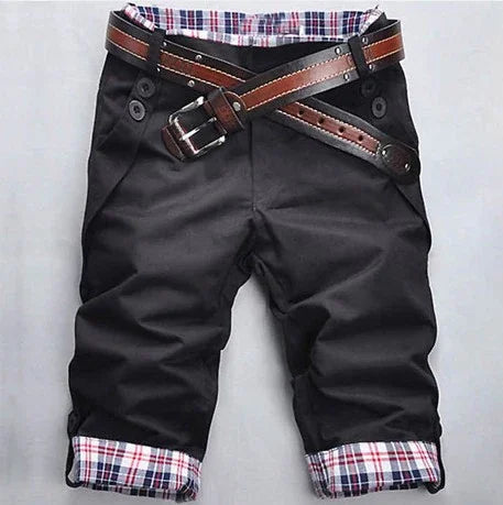 Black men's cuffed pants with plaid lining and double brown leather belts crossed at the waist