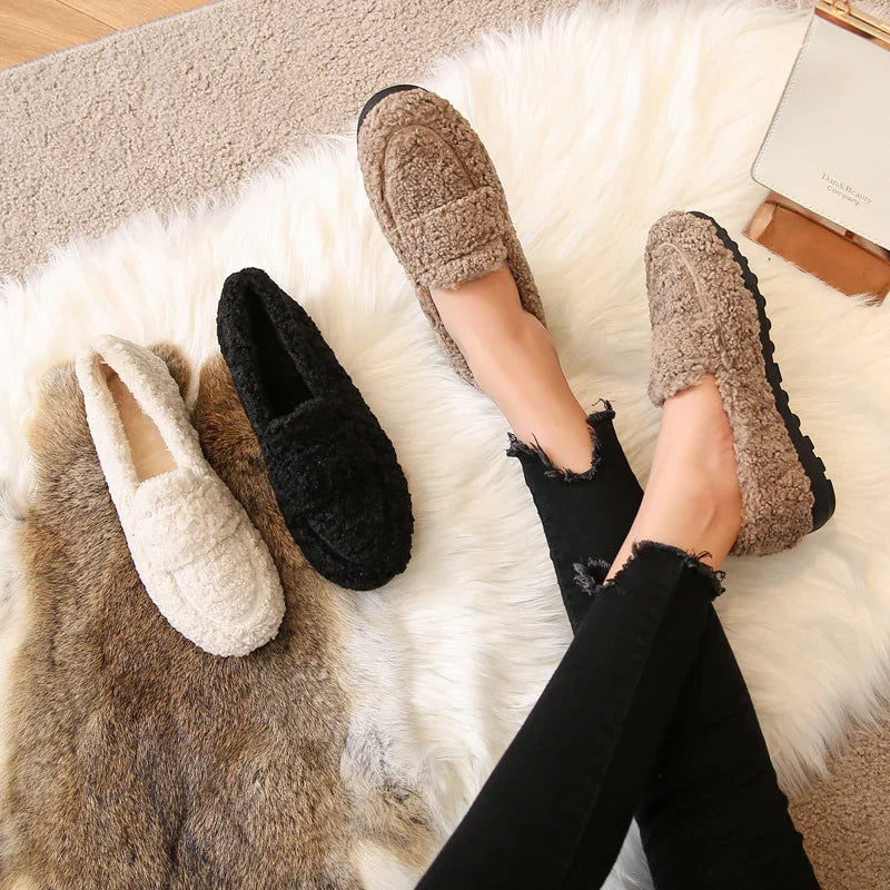 Cozy women's sherpa loafers in beige, black, and cream displayed on fur rugs, casual winter footwear