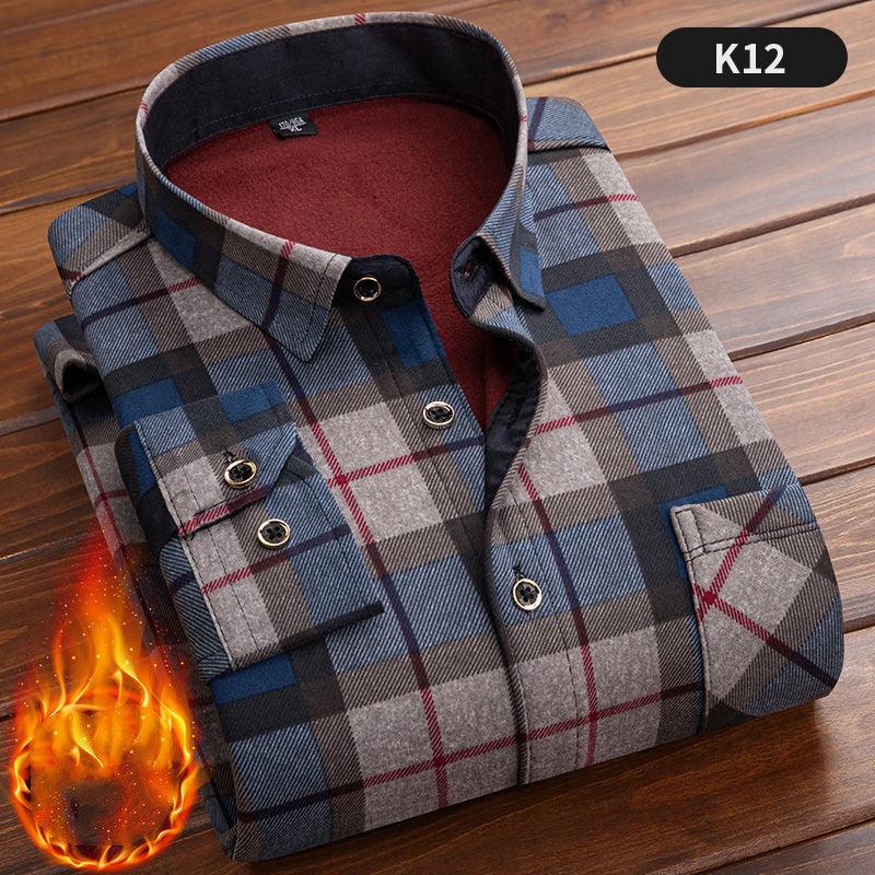 Folded blue gray and red plaid flannel shirt with buttoned cuffs on wooden surface featuring warm lining and fire graphic