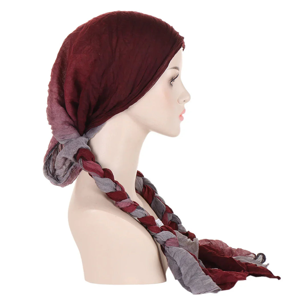 Side view of mannequin wearing burgundy and gray braided cotton headscarf on white background