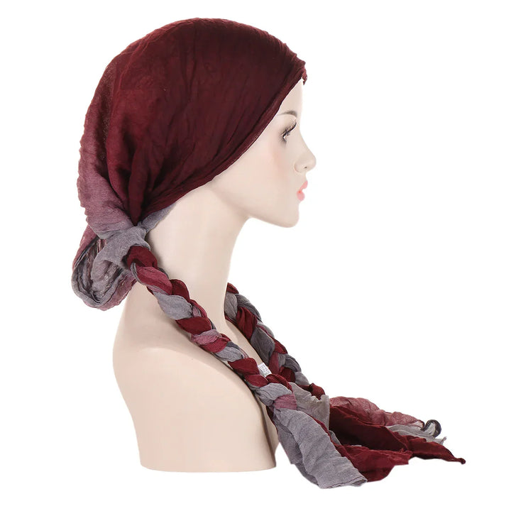 Side view of mannequin wearing burgundy and gray braided cotton headscarf on white background