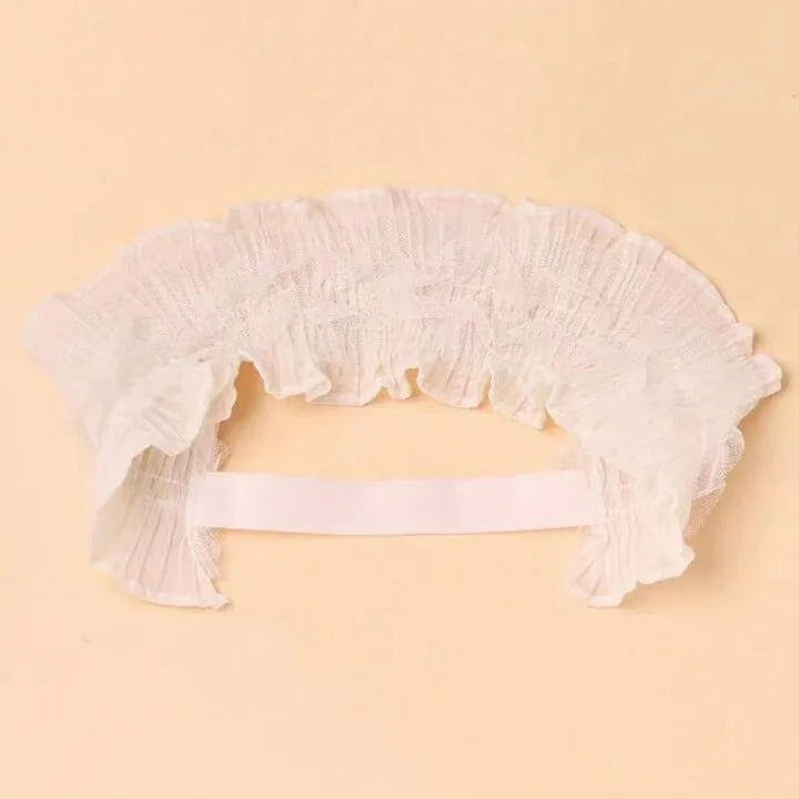 White ruffled lace collar with elastic band on beige background, vintage fashion accessory