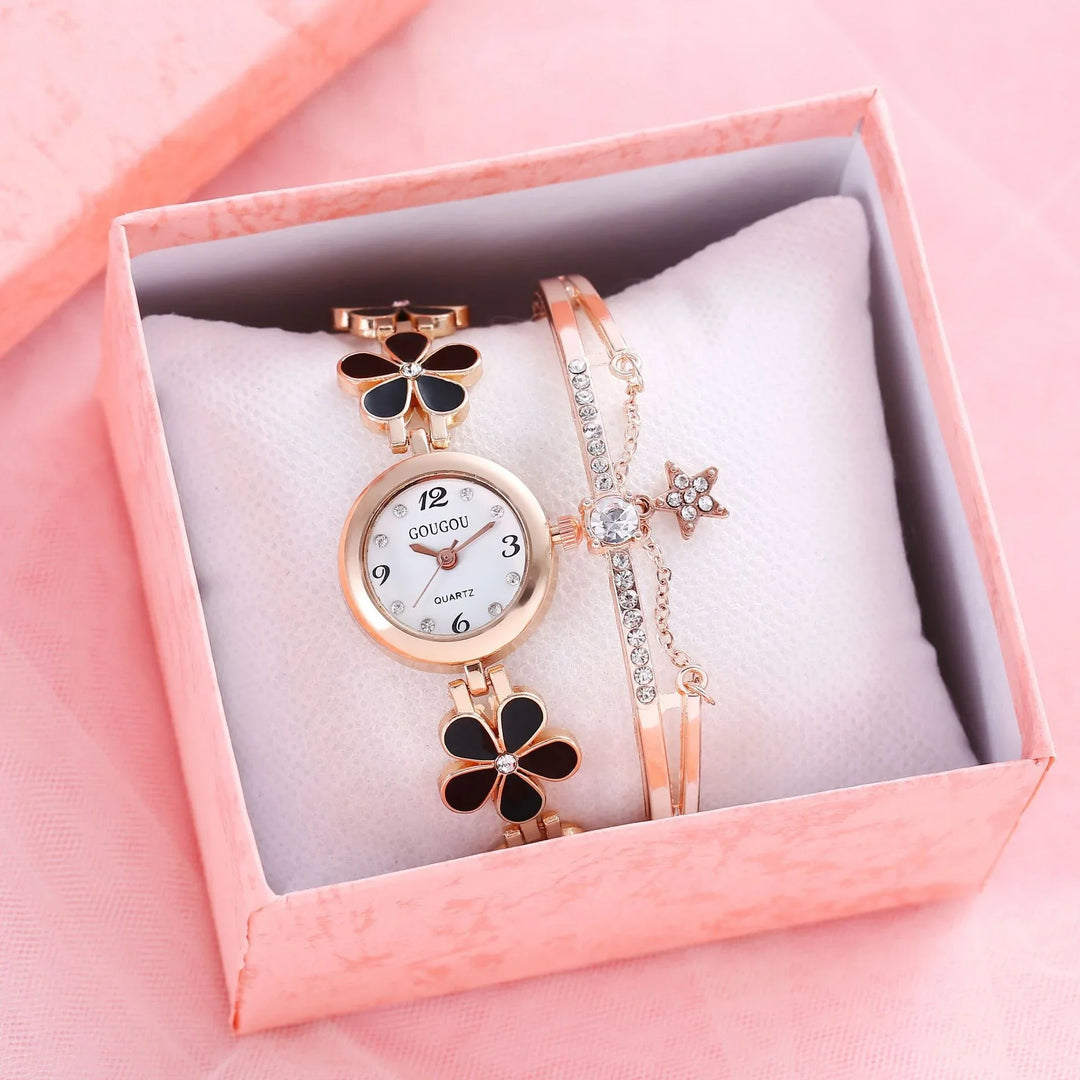 Rose gold women's wristwatch with black flower links and crystal-accented bracelet in pink gift box