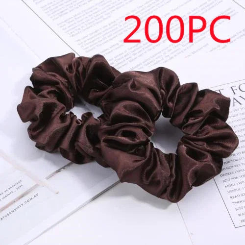 Two dark brown satin scrunchies on white paper background with red text 200PC