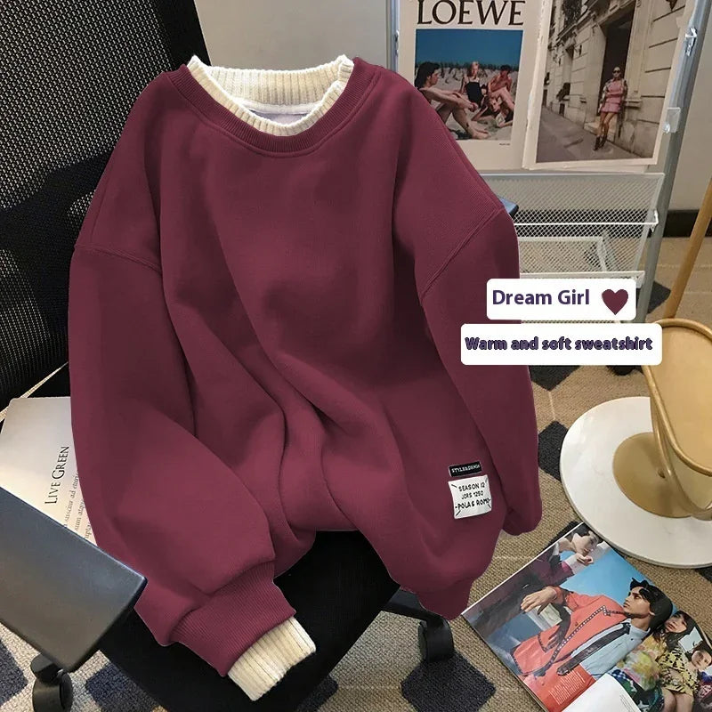 Burgundy warm and soft sweatshirt with ribbed cuffs on office chair, fashion magazines nearby