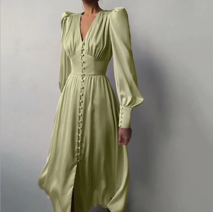 Woman wearing elegant light green midi dress with puffed shoulders, long sleeves, and front buttons