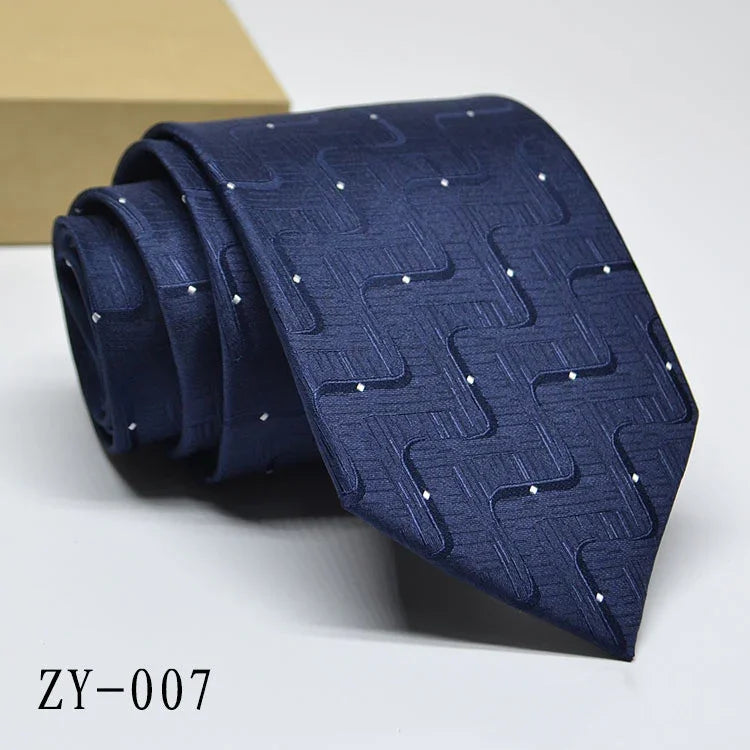 Navy blue men's silk tie with geometric pattern and white dot accents, elegant formal accessory