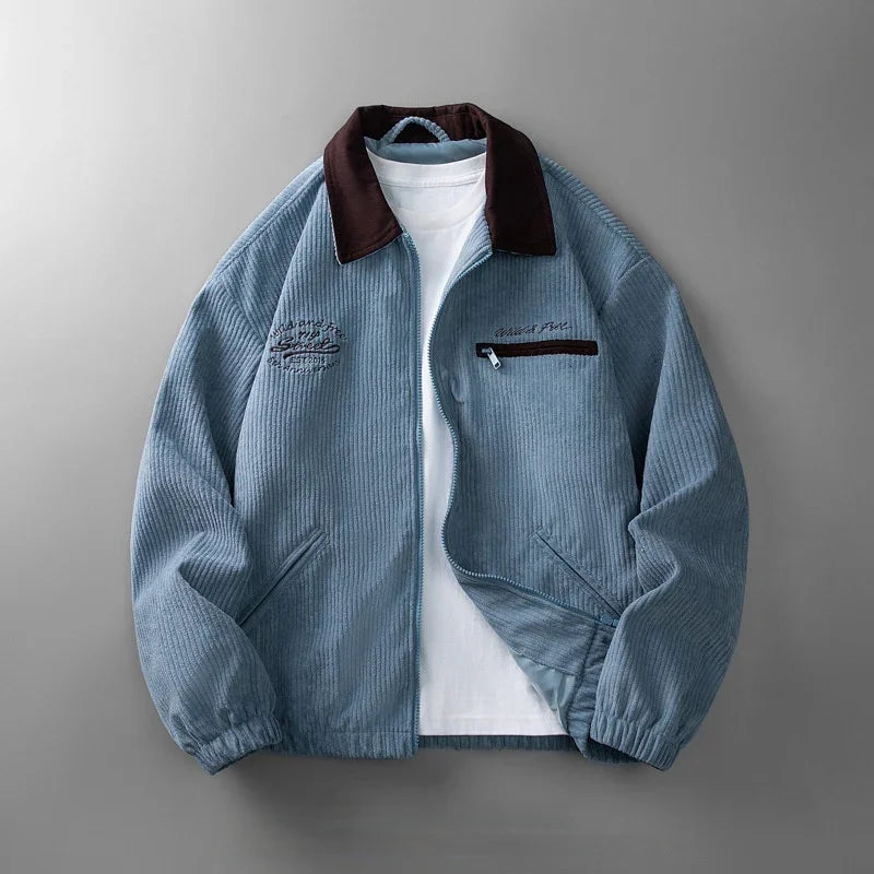 Light blue corduroy jacket with dark brown collar and white zipper pocket, layered over white t-shirt