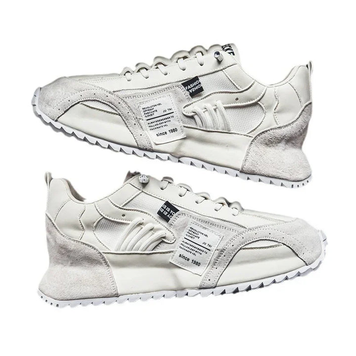 pair of white and beige casual sneakers with fabric and suede panels on white background