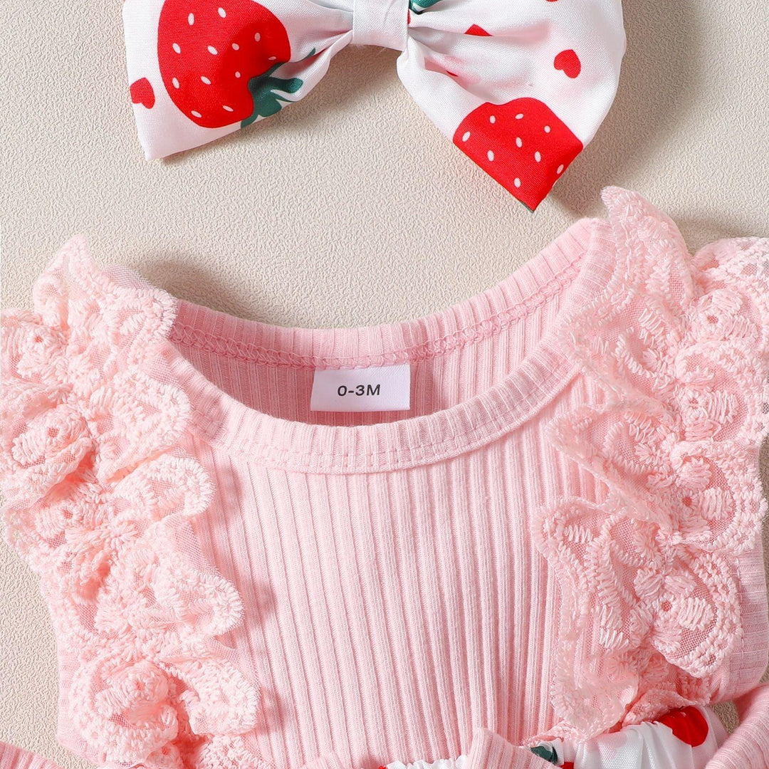 Close-up of pink ribbed baby onesie with lace ruffles and 0-3M size tag, strawberry print bow