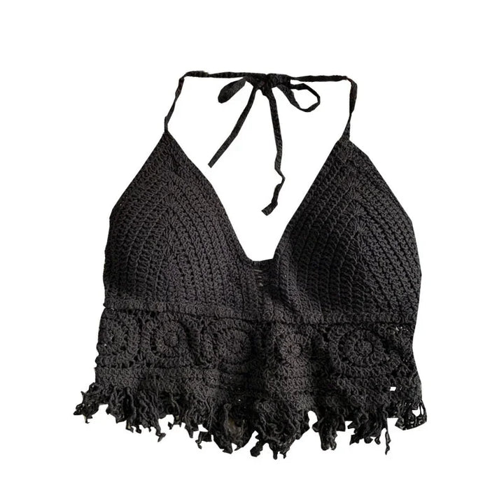 Black crochet halter top with floral pattern and fringe hem, isolated on white background