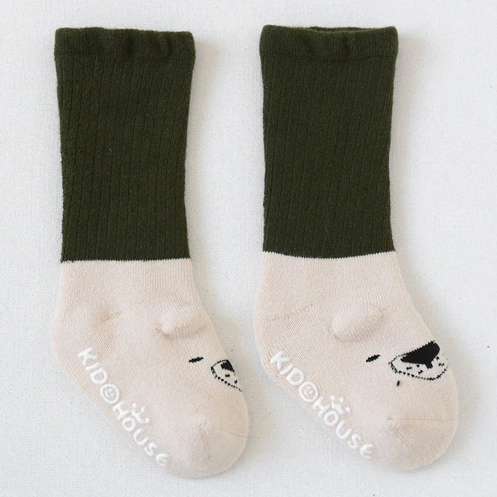 Pair of children's socks with dark green ribbed cuffs and beige feet, featuring bear face design and KidHouse logo