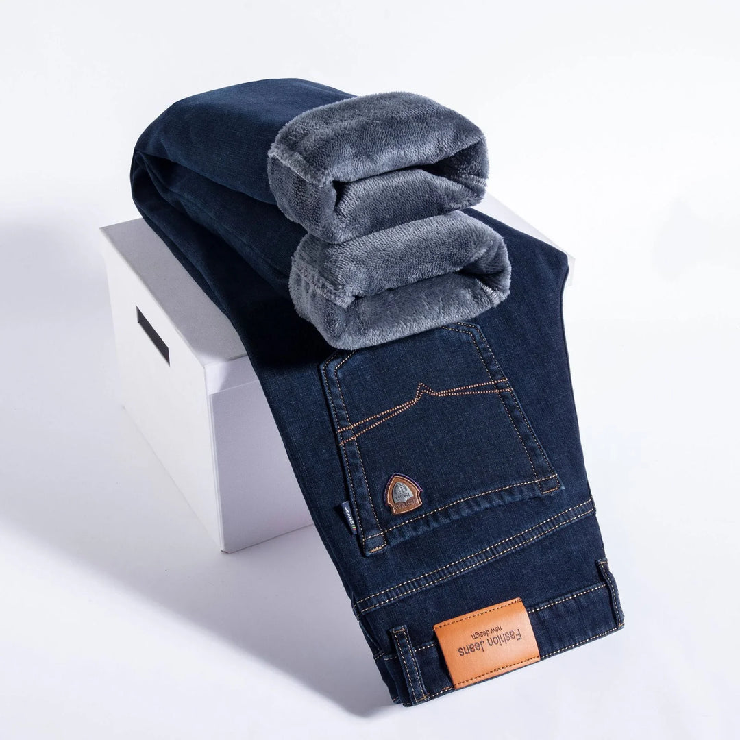 Dark blue fashion jeans with soft gray fleece lining folded on a white box