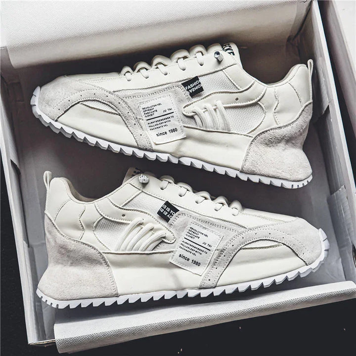 Pair of stylish off-white casual sneakers with textured sole and fabric details in a shoebox