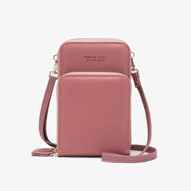 Pink crossbody bag with dual zippered compartments and gold hardware, labeled Forever Lovely