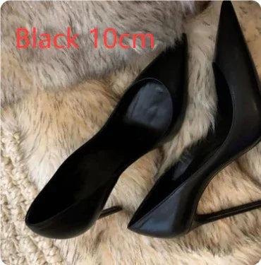 Pair of black 10cm high-heeled pointed-toe shoes on a soft beige fur surface
