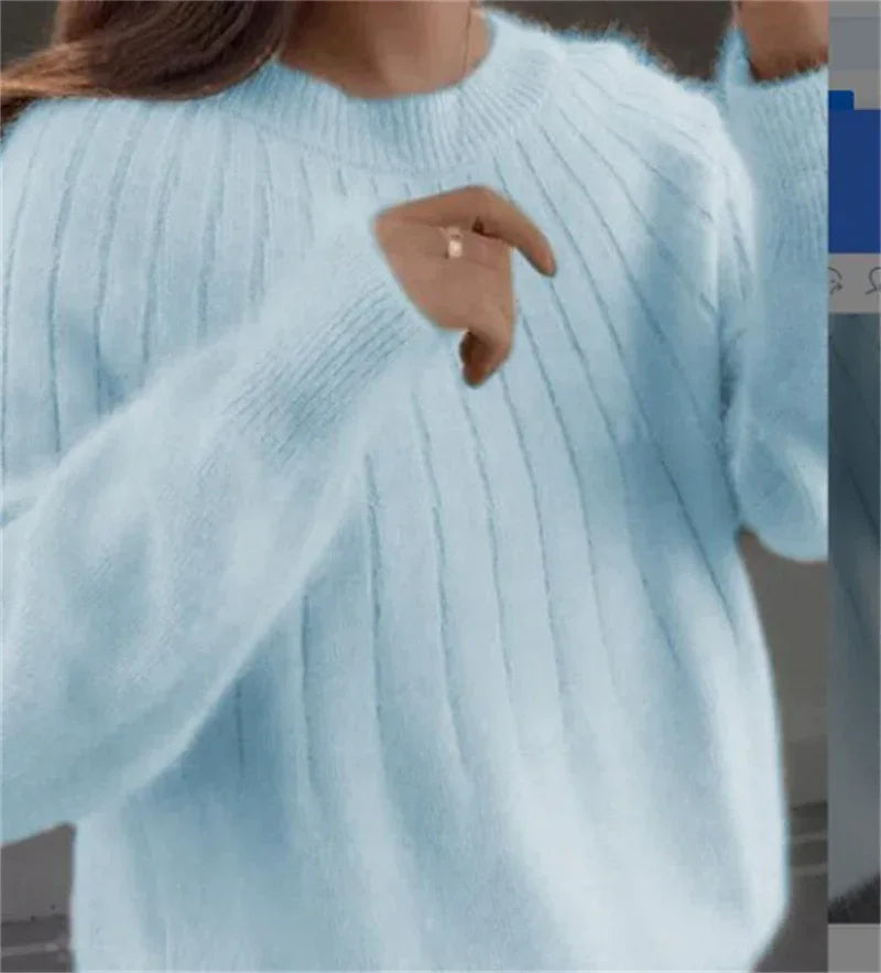 Close-up of person wearing a soft light blue ribbed knit sweater with long sleeves