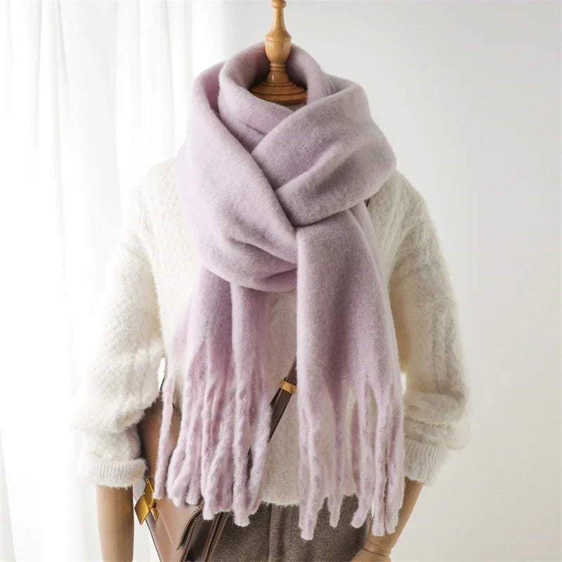 Soft lavender wool scarf with fringes styled on mannequin wearing white textured sweater