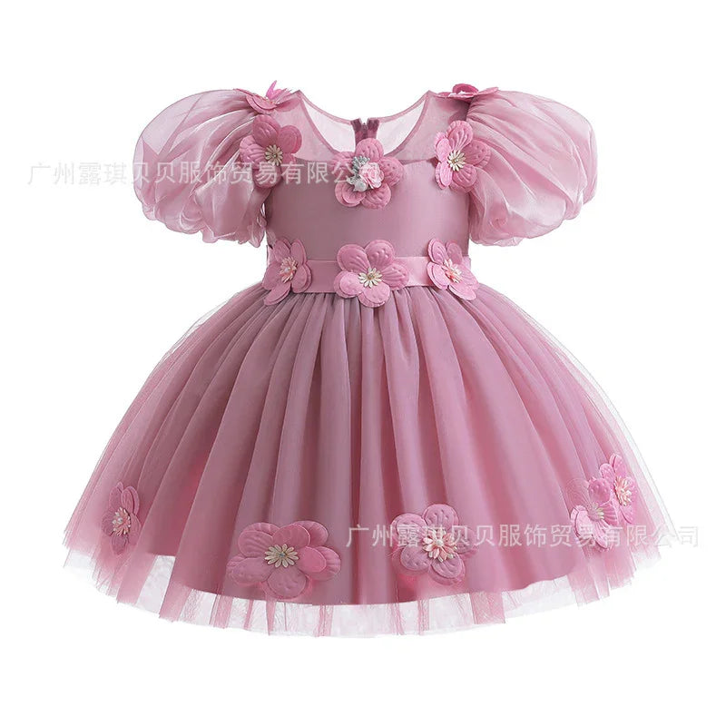 Pink toddler dress with puff sleeves and 3D floral appliques on bodice and skirt