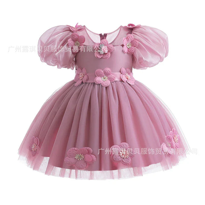 Pink toddler dress with puff sleeves and 3D floral appliques on bodice and skirt