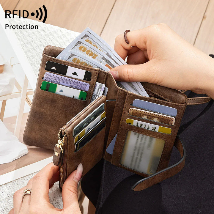 Brown leather RFID protection wallet open showing credit cards and hundred-dollar bills