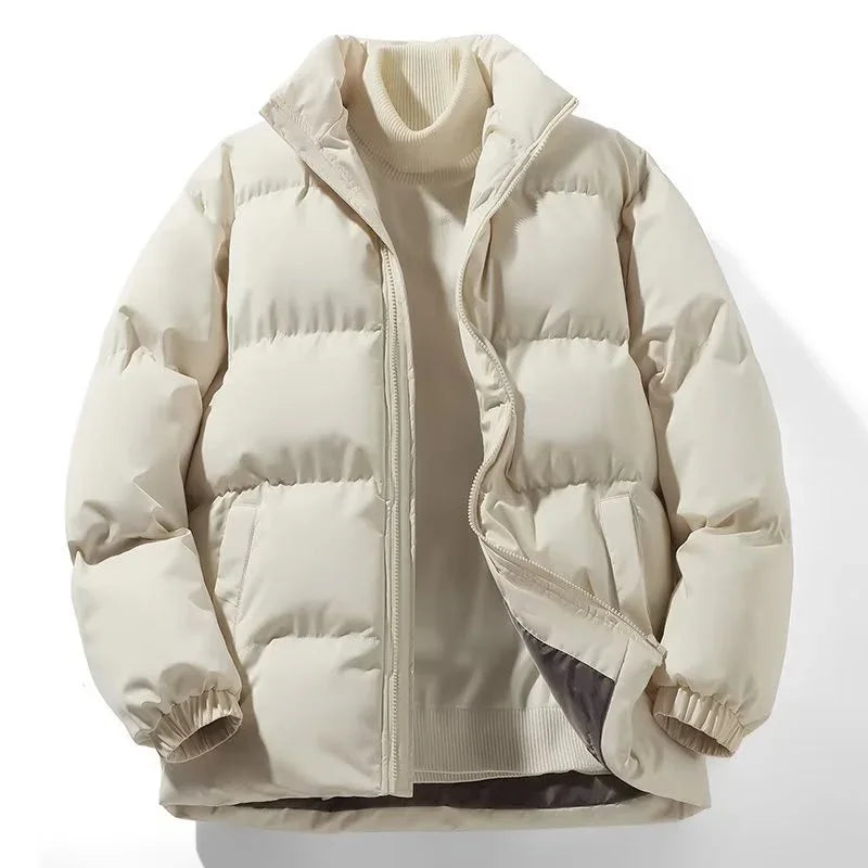 Beige quilted puffer jacket with front zipper over a cream turtleneck sweater on white background