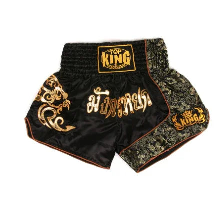 Black Top King Muay Thai shorts with gold embroidery and intricate dragon pattern