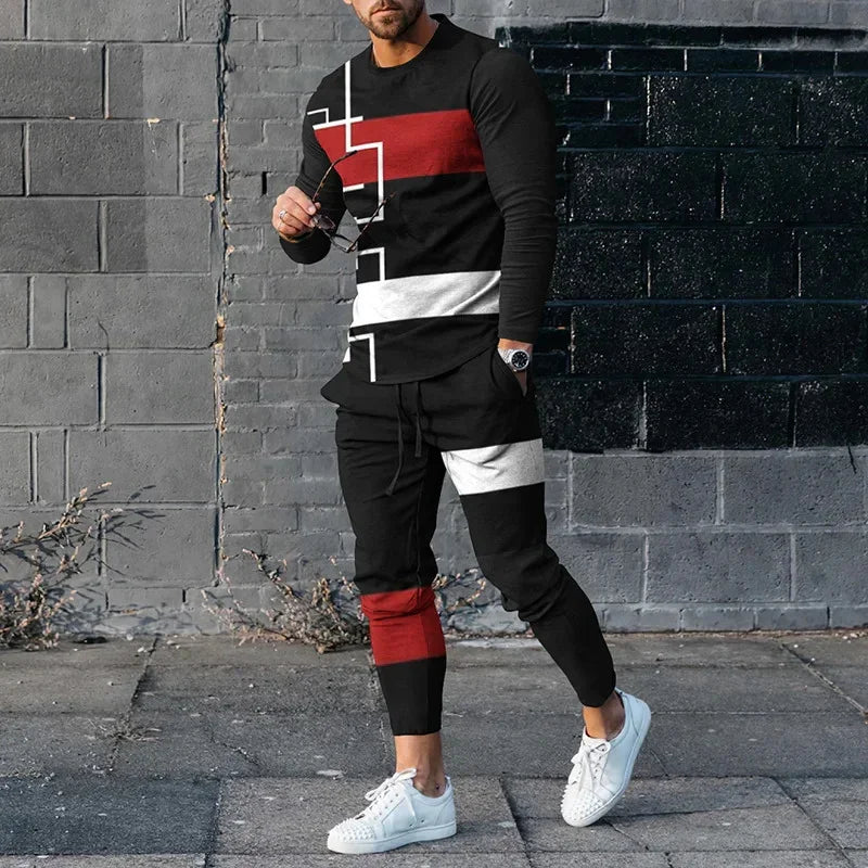 Man wearing black tracksuit with red and white geometric stripes and white sneakers against gray brick wall