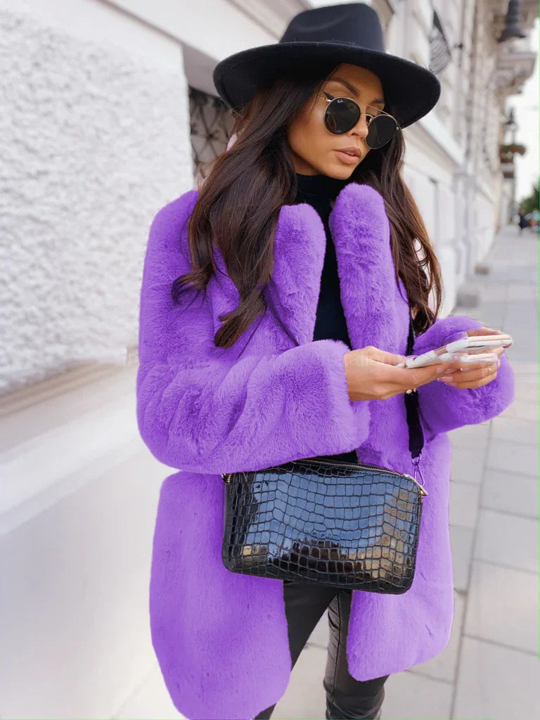 Woman wearing a vibrant purple faux fur coat, black hat, round sunglasses, and carrying a black crocodile leather handbag on city street