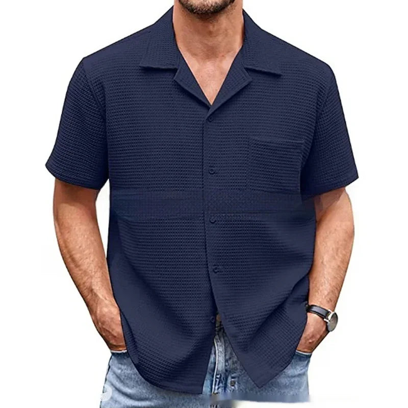 man wearing navy blue short sleeve textured button-up shirt with collar and pocket