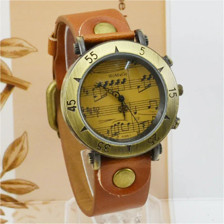 Vintage wristwatch with brass bezel and brown leather strap featuring music sheet dial design