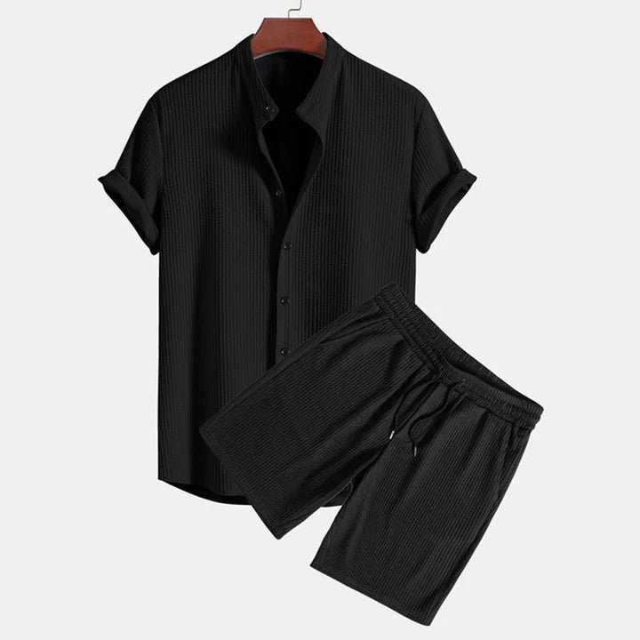 Black ribbed short sleeve button-up shirt and drawstring shorts set on hanger