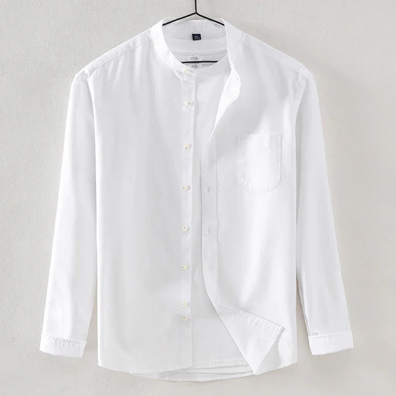 White long-sleeve mandarin collar shirt with front pocket hanging on hanger