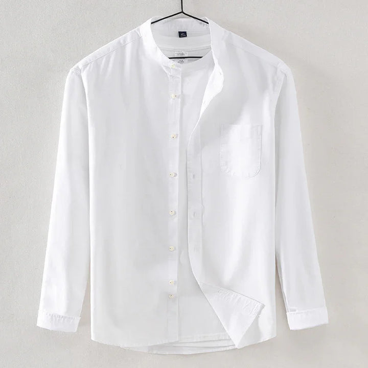 White long-sleeve mandarin collar shirt with front pocket hanging on hanger