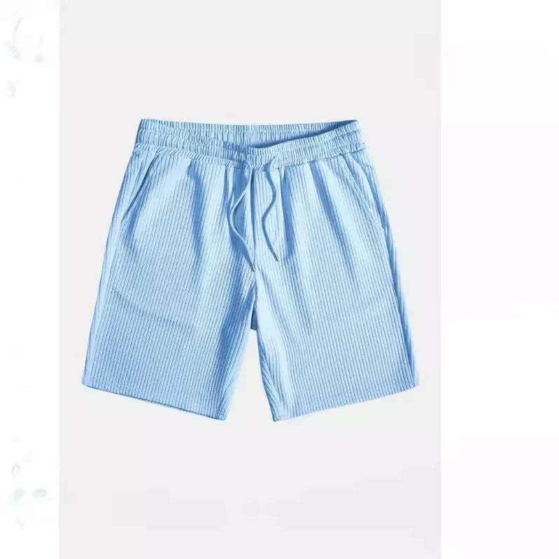 Light blue ribbed knit casual shorts with elastic waistband and drawstring on white background