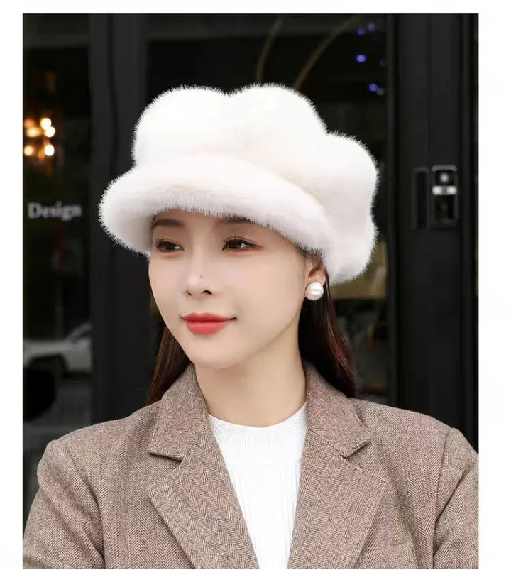 Woman wearing white fluffy fur hat and brown herringbone coat with pearl earrings