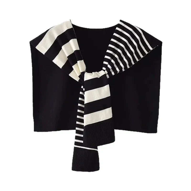 Black knit sweater with black and white striped scarf draped over shoulders