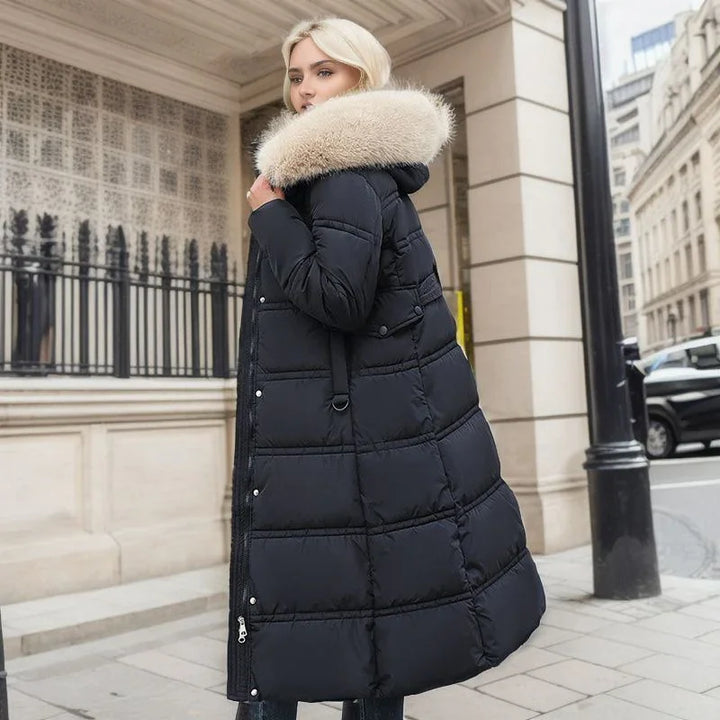 Blonde woman wearing long black puffer coat with large beige fur collar in urban street setting